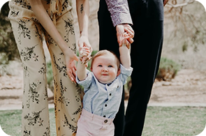 Adult holding a child, representing family investment